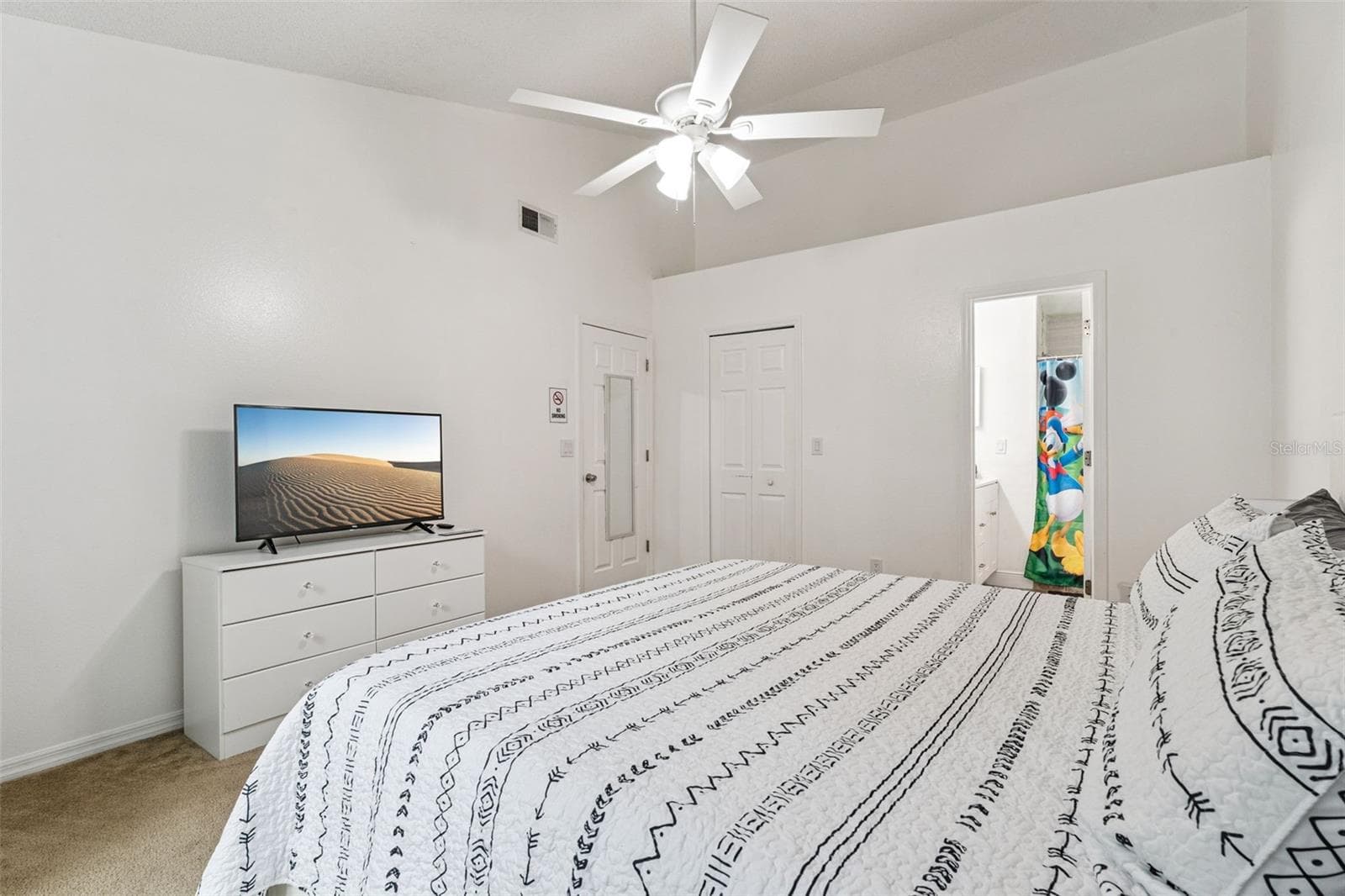Primary Bedroom Suite View: Primary bedroom view looking toward the double closet doors and private ensuite bathroom access. - 5017 LAGUNA BAY CIR #100, KISSIMMEE