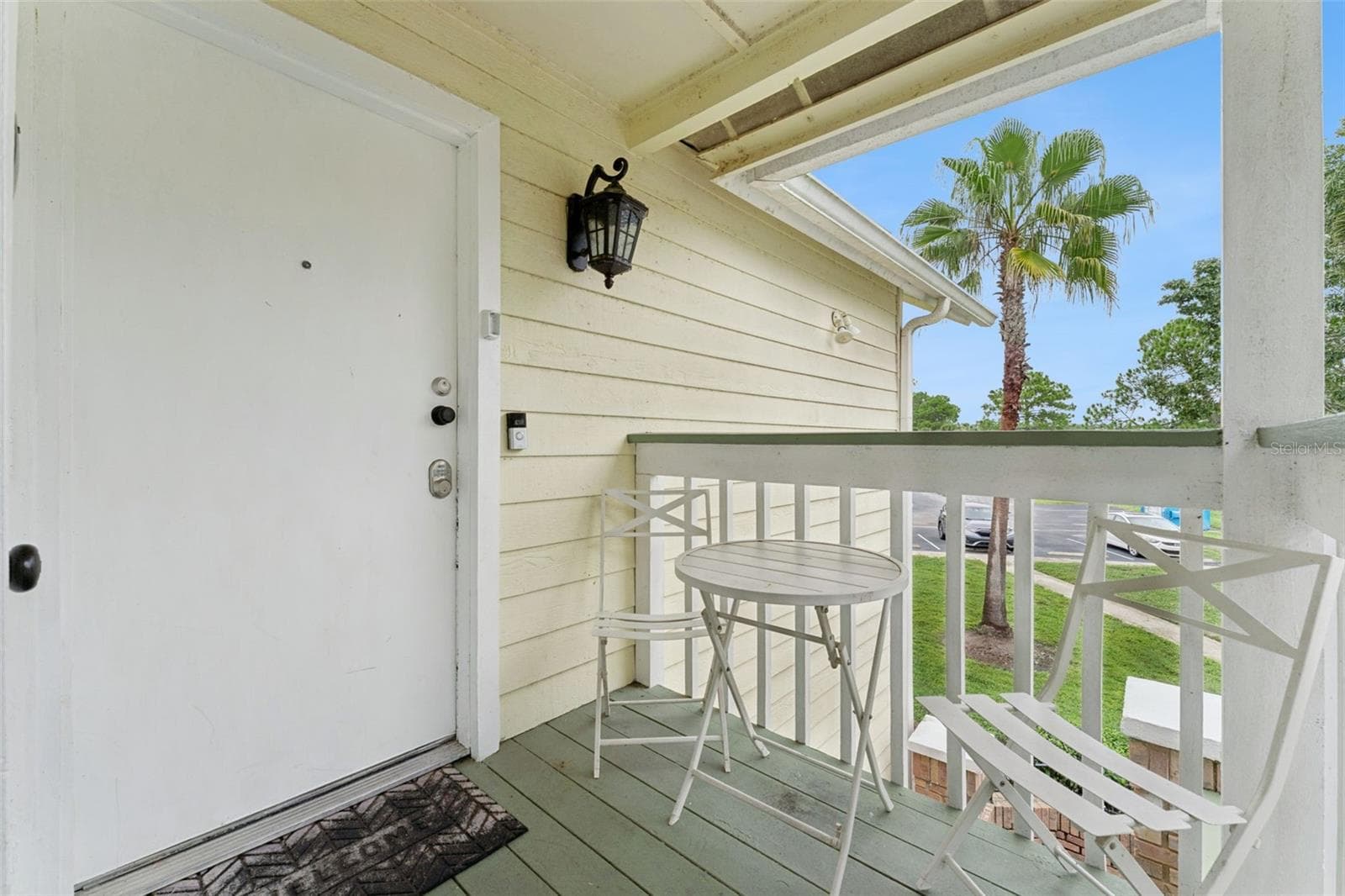 Private Porch Entry: Secluded covered entry balcony with room for small patio seating and views of the community grounds - 5017 LAGUNA BAY CIR #100, KISSIMMEE