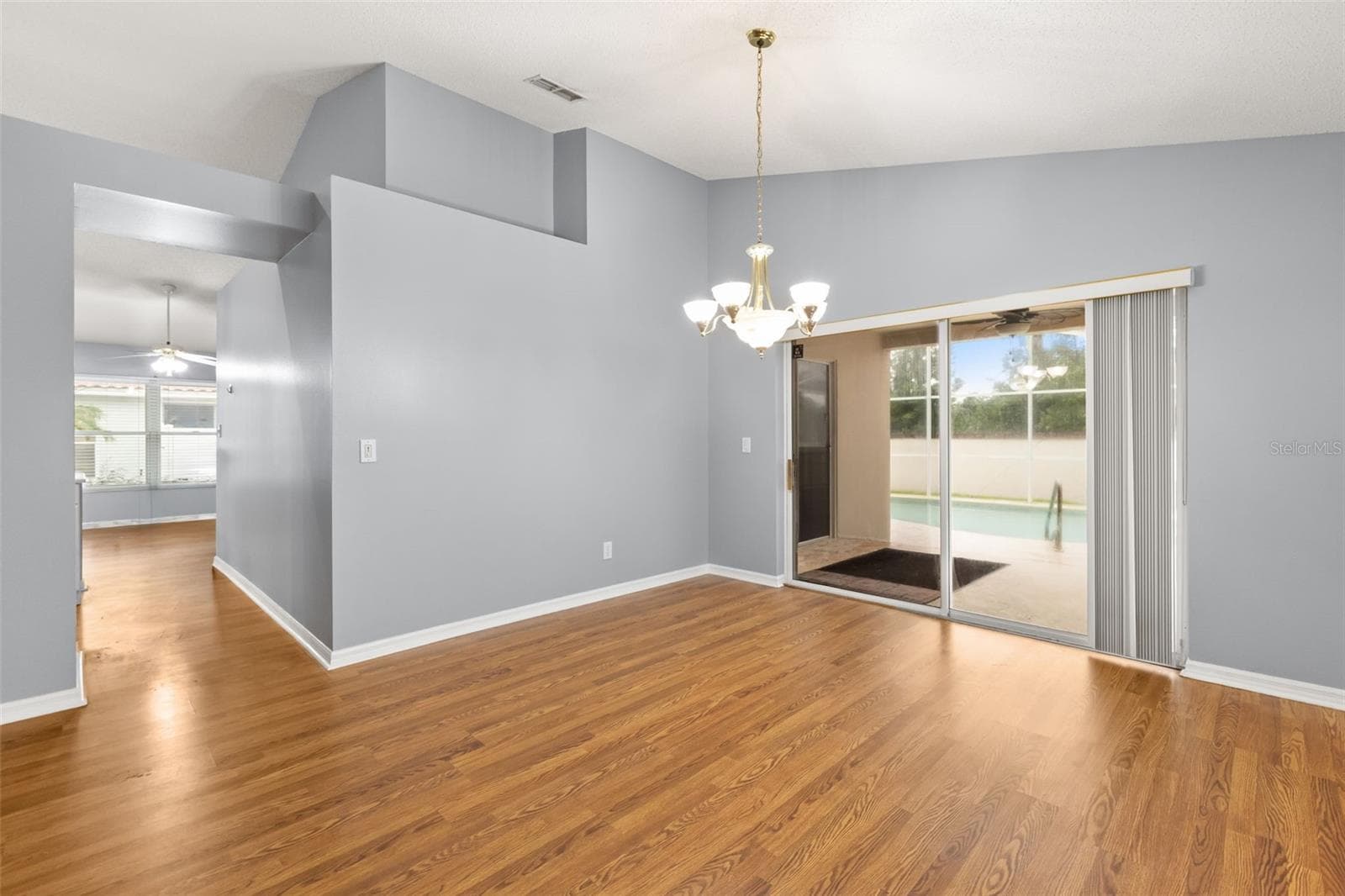 Dining with view of pool and lanai and hallway to you kitchen and family room - 755 VIA MILANO, APOPKA