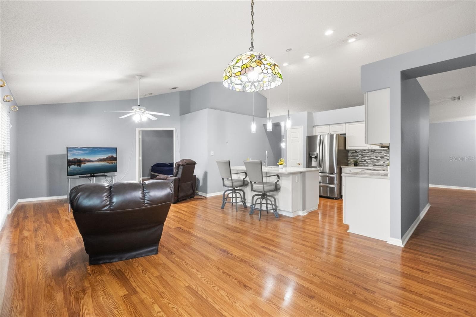 Same view of family and dinette with current owner's furniture - 755 VIA MILANO, APOPKA