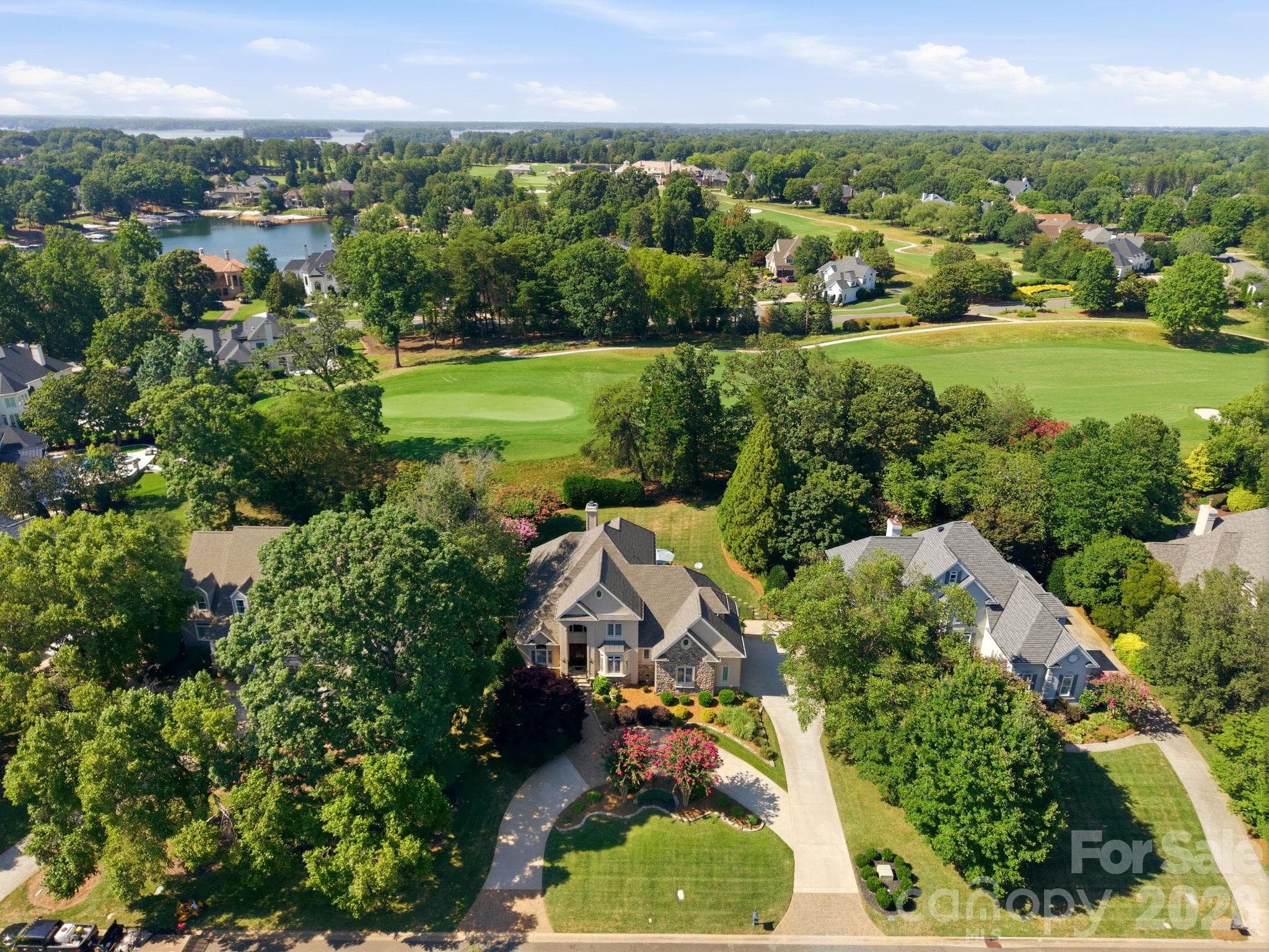 Take in the bird's-eye view of your expansive property and lush, tree-lined surroundings. - 18416 Peninsula Club Drive, Cornelius