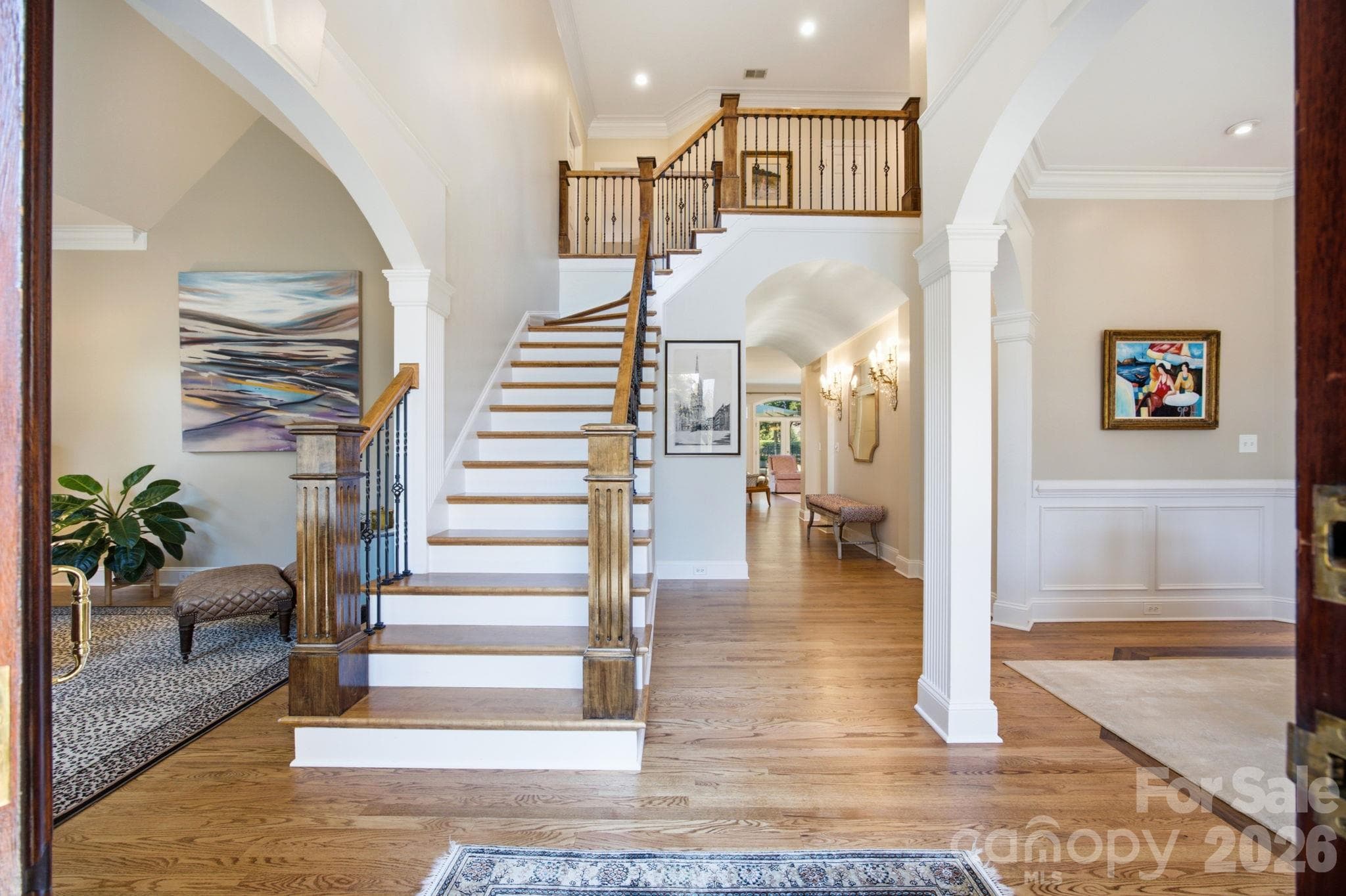 Make a lasting first impression with this grand foyer, where soaring vaulted ceilings and a sweeping staircase set the stage. - 18416 Peninsula Club Drive, Cornelius