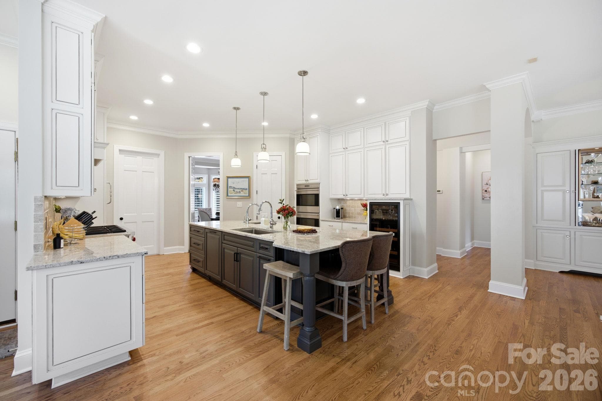 The heart of the home: a bright, beautiful kitchen designed for casual mornings around the center island. - 18416 Peninsula Club Drive, Cornelius