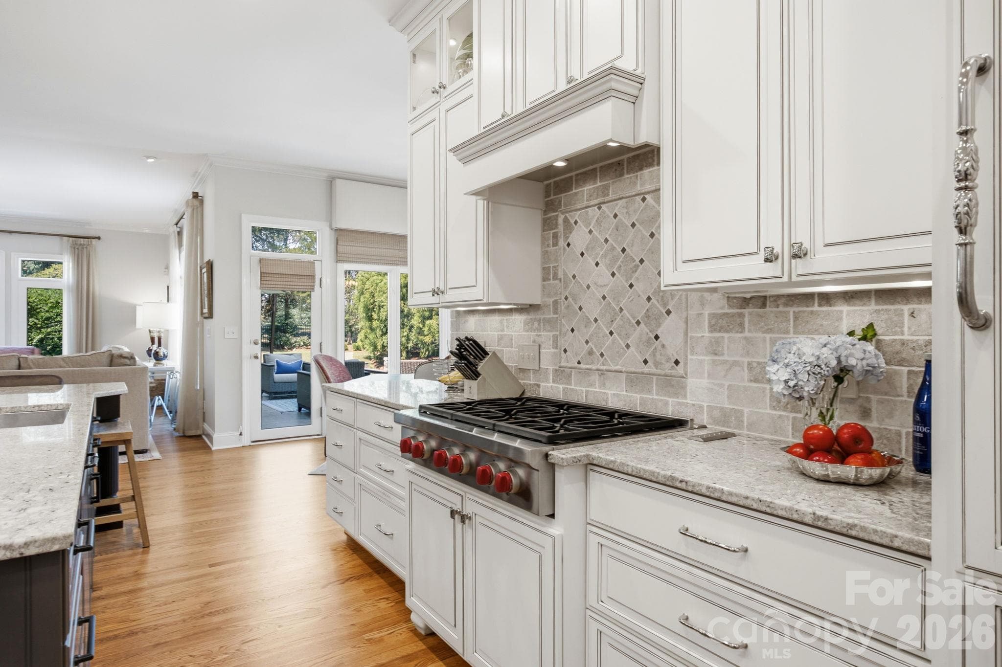 Channel your inner chef with high-end finishes, custom cabinetry, and prep space galore. - 18416 Peninsula Club Drive, Cornelius