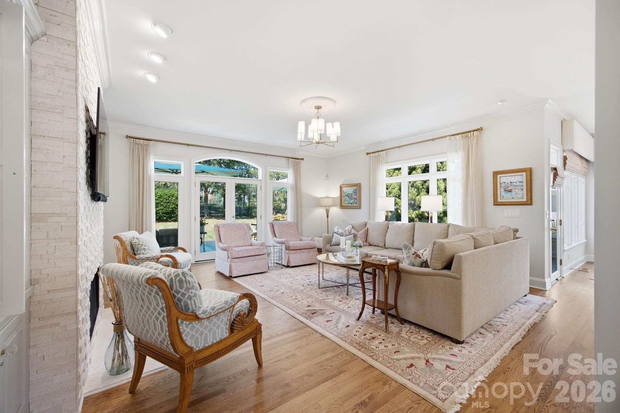 A bright, welcoming main-level living room designed for comfort and everyday relaxation. - 18416 Peninsula Club Drive, Cornelius