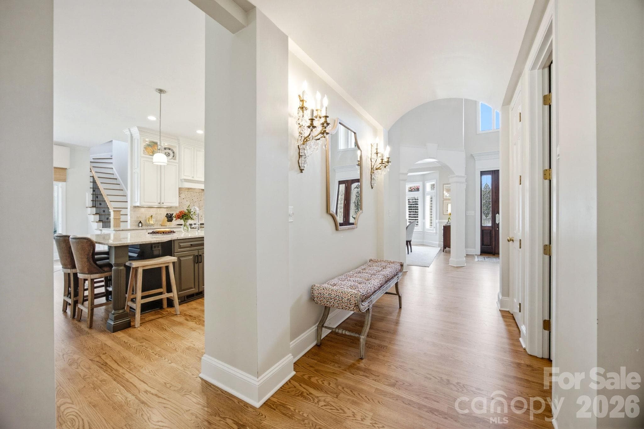 A graceful transitional hallway connecting the home's vibrant spaces. - 18416 Peninsula Club Drive, Cornelius