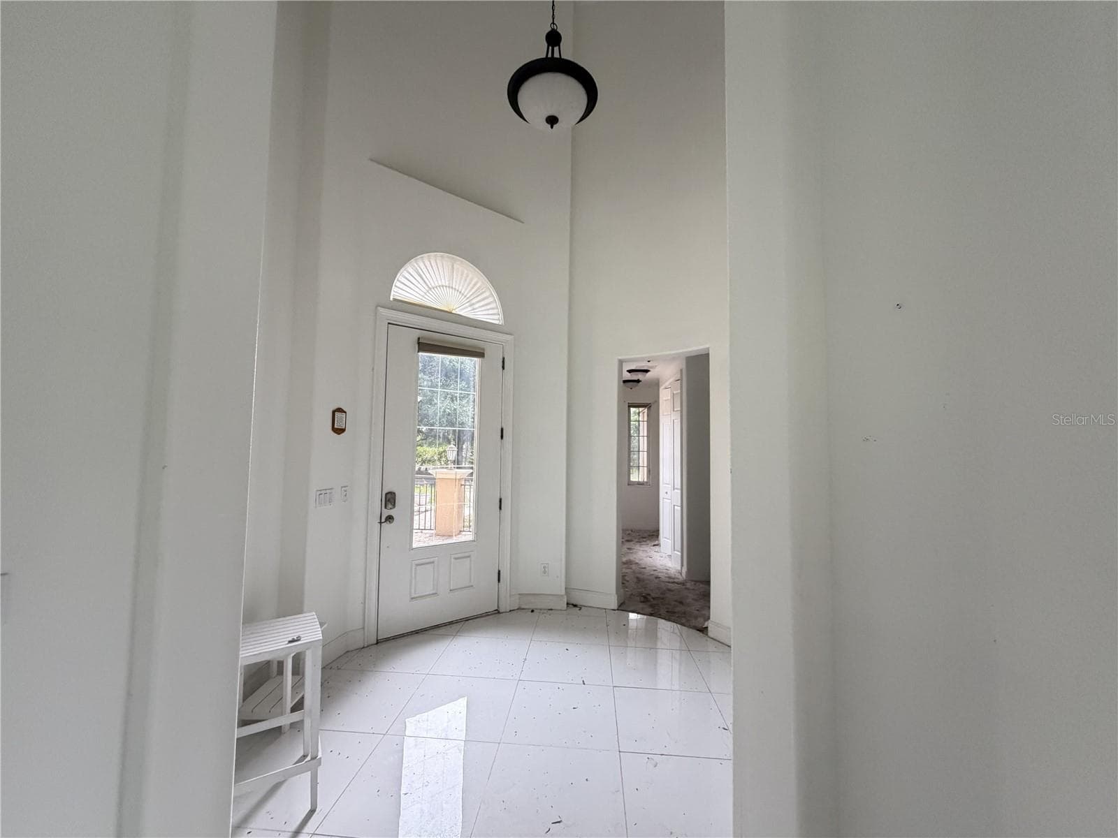 Entry foyer with high ceiling and glass-paneled front door. - 39539 HARBOR HILLS BLVD, LADY LAKE