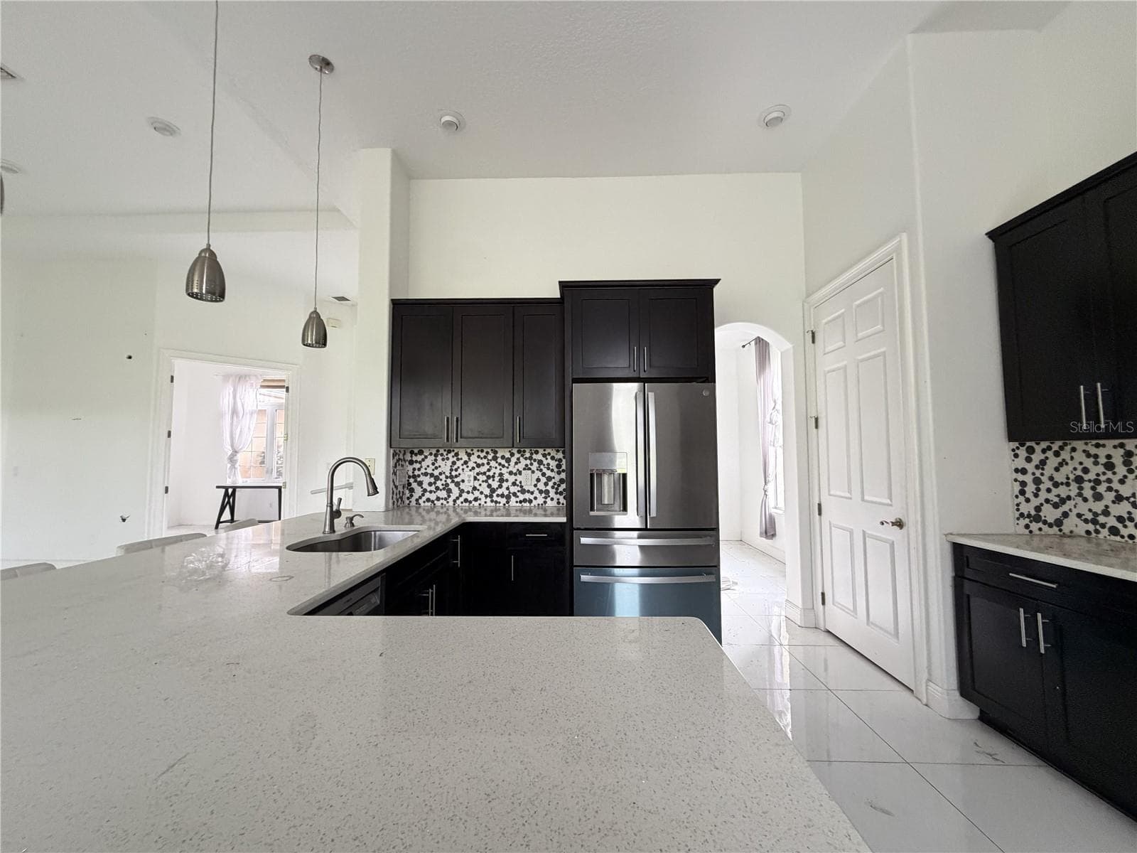 Dark cabinets, light countertops, stainless-steel appliances, and sink. - 39539 HARBOR HILLS BLVD, LADY LAKE