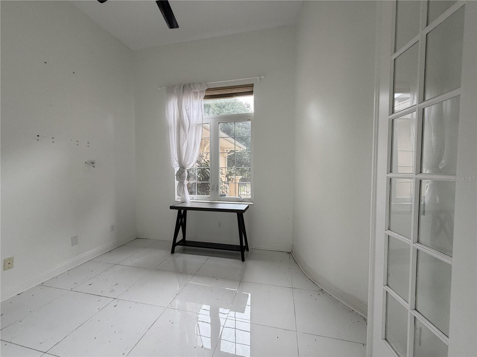 Separate study/den with ceiling fan, window, and glass-paneled door. - 39539 HARBOR HILLS BLVD, LADY LAKE