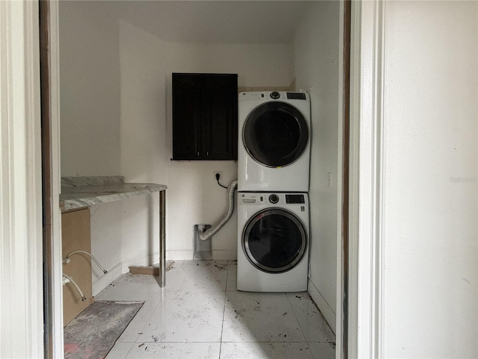 Laundry room with stacked appliances; utility sink and lower cabinetry removed. - 39539 HARBOR HILLS BLVD, LADY LAKE
