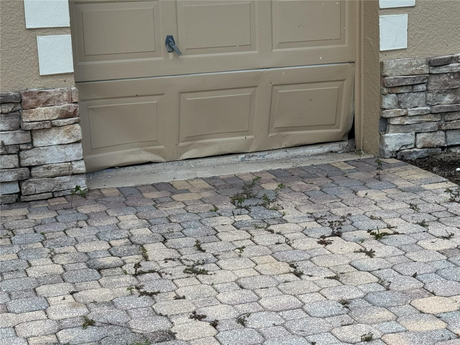 Damage to lower panels of golf cart garage door. - 39539 HARBOR HILLS BLVD, LADY LAKE