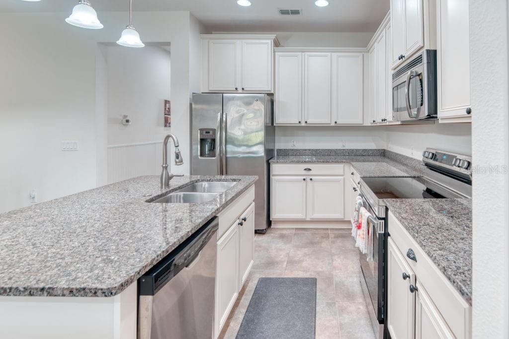 Kitchen with Stainless Steel Appliances - 3432 FALLBROOK DR, POINCIANA