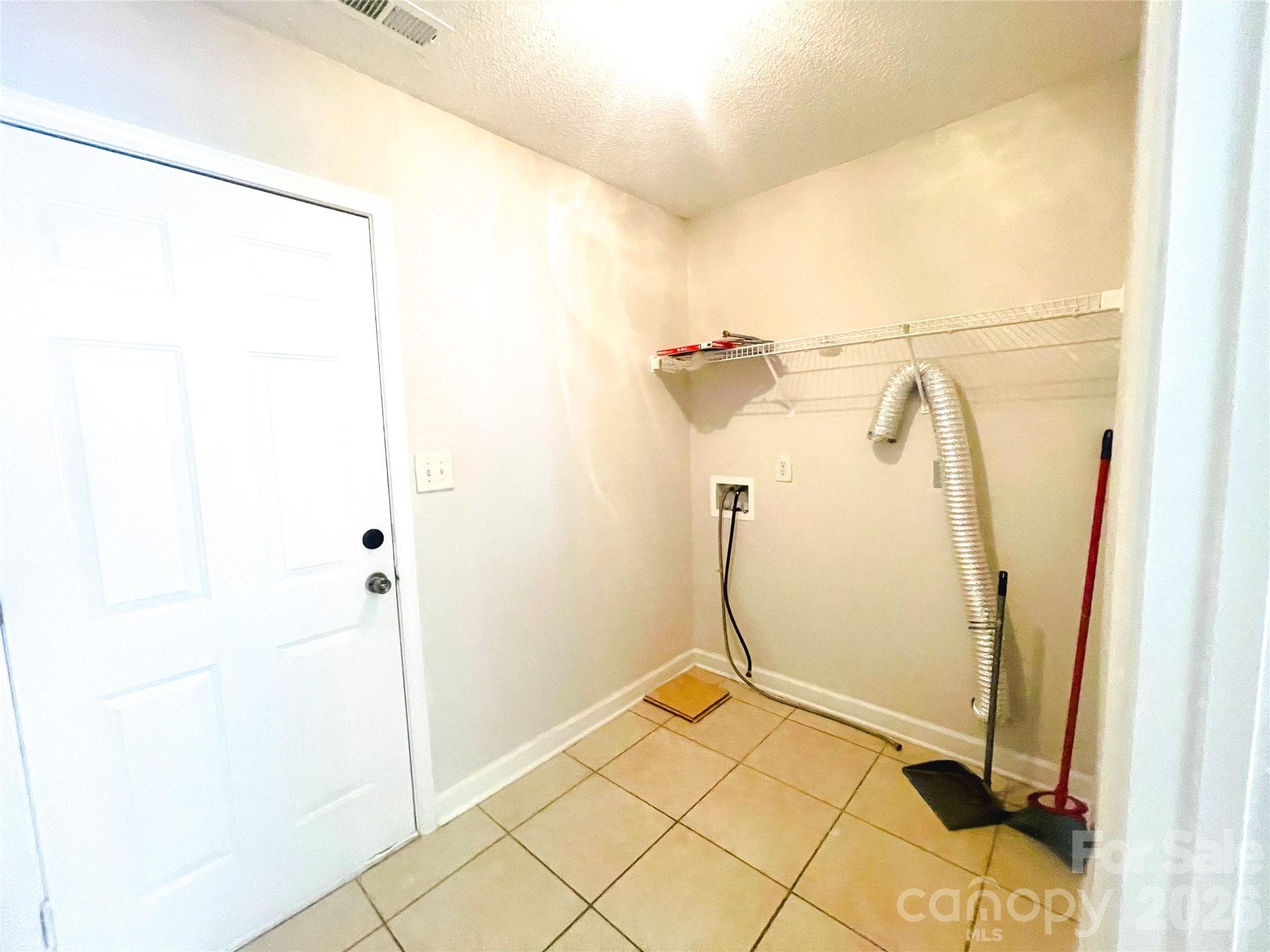 Laundry room in mud room / entry from garage between garage and kitchen - 1011 Cadberry Court, Indian Trail