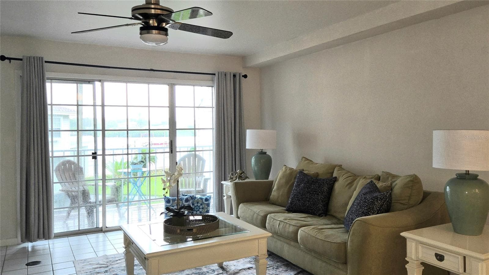 Living Room has sliding doors to a Private Deck overlooking the pool and waterfront. - 19201 VISTA LN #D2, INDIAN SHORES