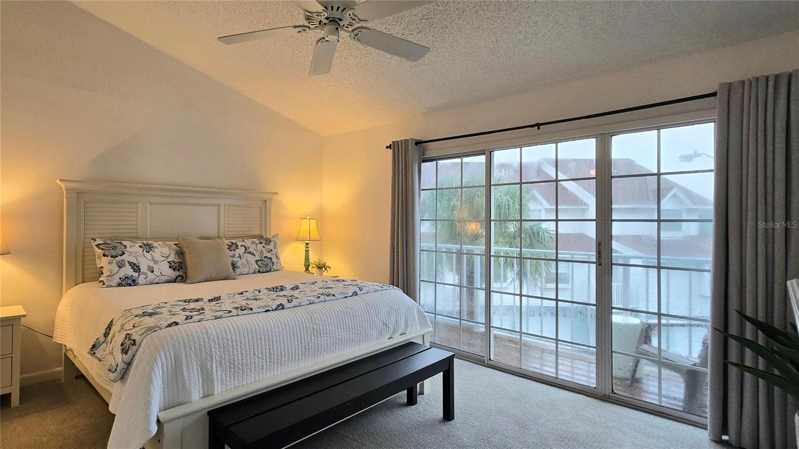 Primary Suite with sliding doors to a Private Balcony with Water View. - 19201 VISTA LN #D2, INDIAN SHORES
