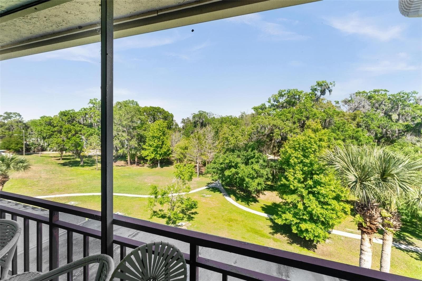 Living Room Overlooking Wooded Area Leading to the Lake - 1162 CARMEL CIR #440, CASSELBERRY