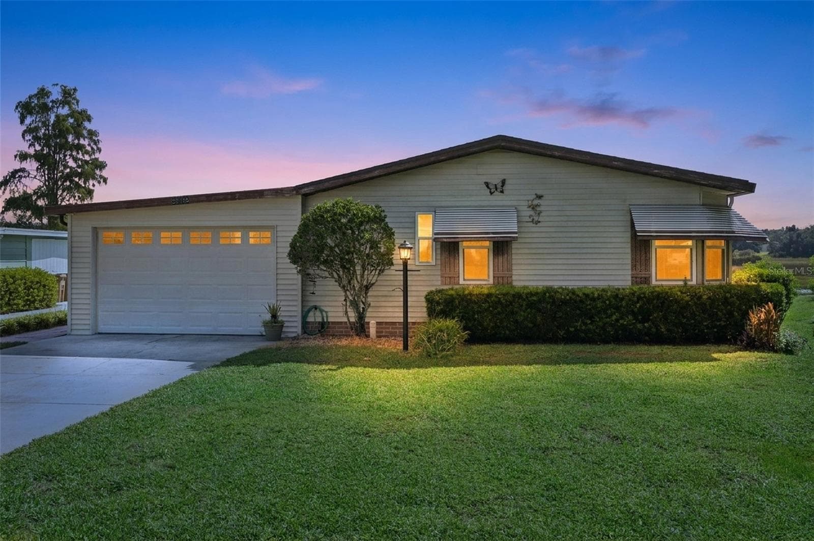 Digitally enhanced virtual twilight: front exterior with attached garage and landscaped front yard - 25038 CLIFFORD HL, LEESBURG