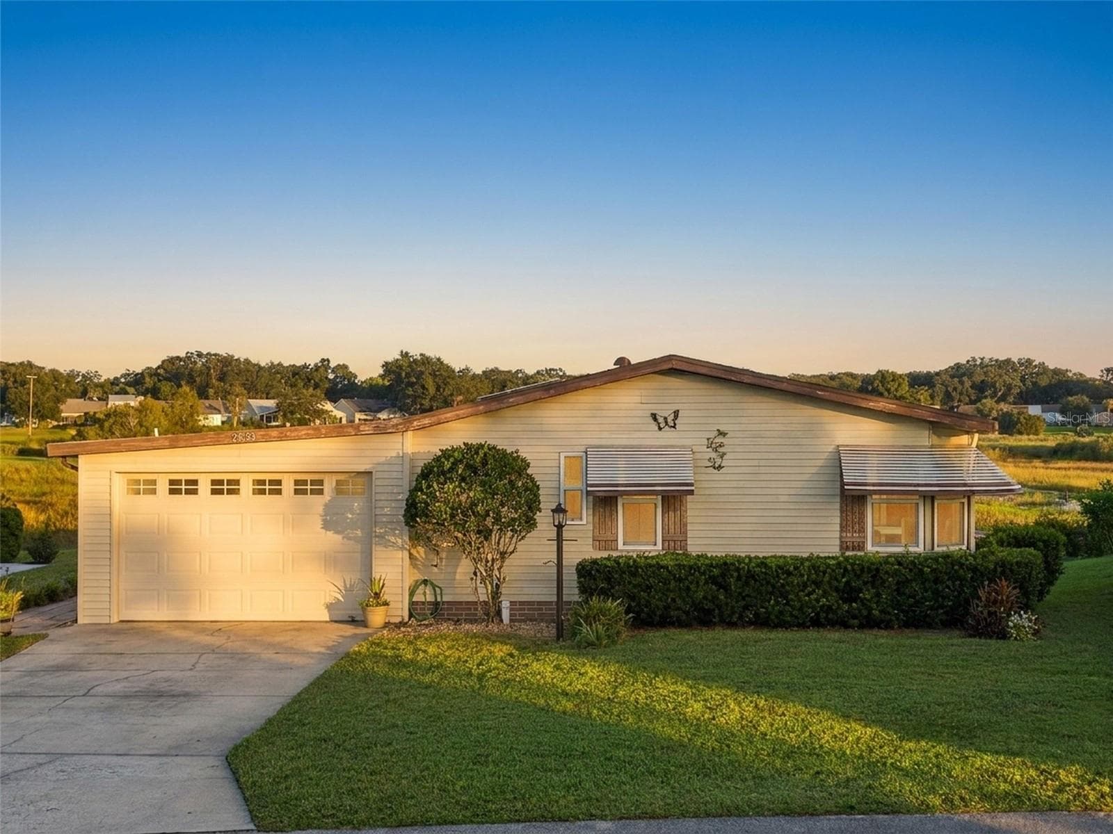 Digitally enhanced golden-hour light: elevated front view with the open marsh behind - 25038 CLIFFORD HL, LEESBURG