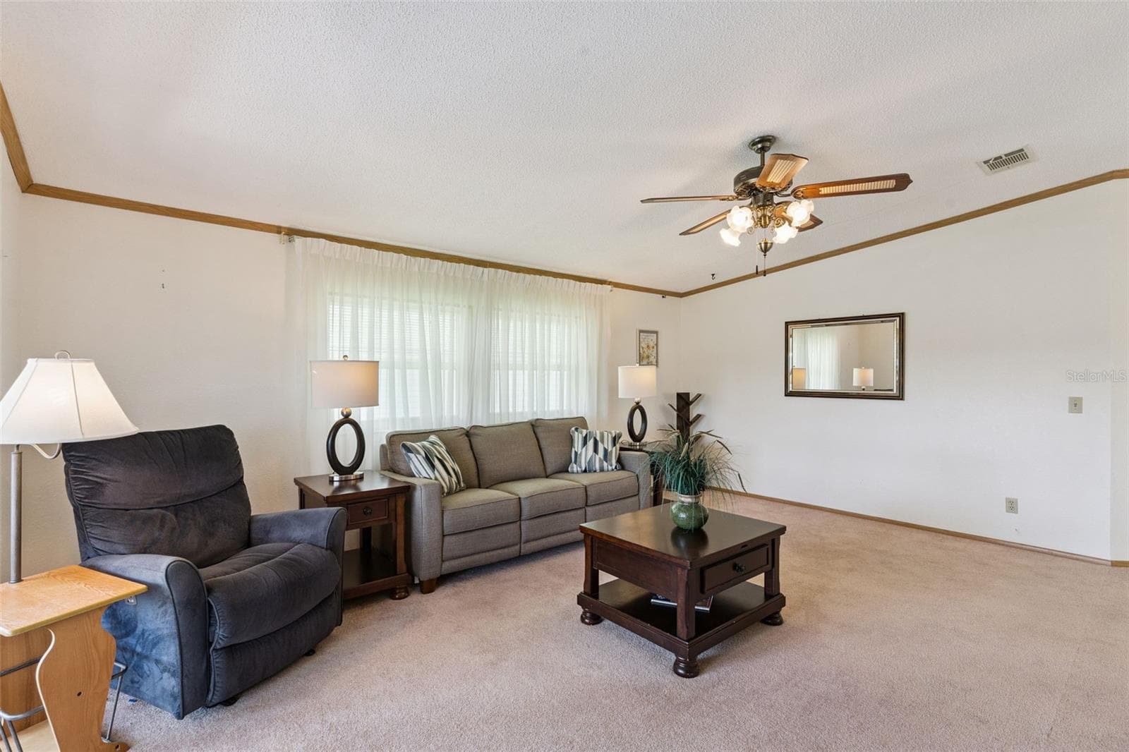 Living room with large front windows and a vaulted ceiling - 25038 CLIFFORD HL, LEESBURG