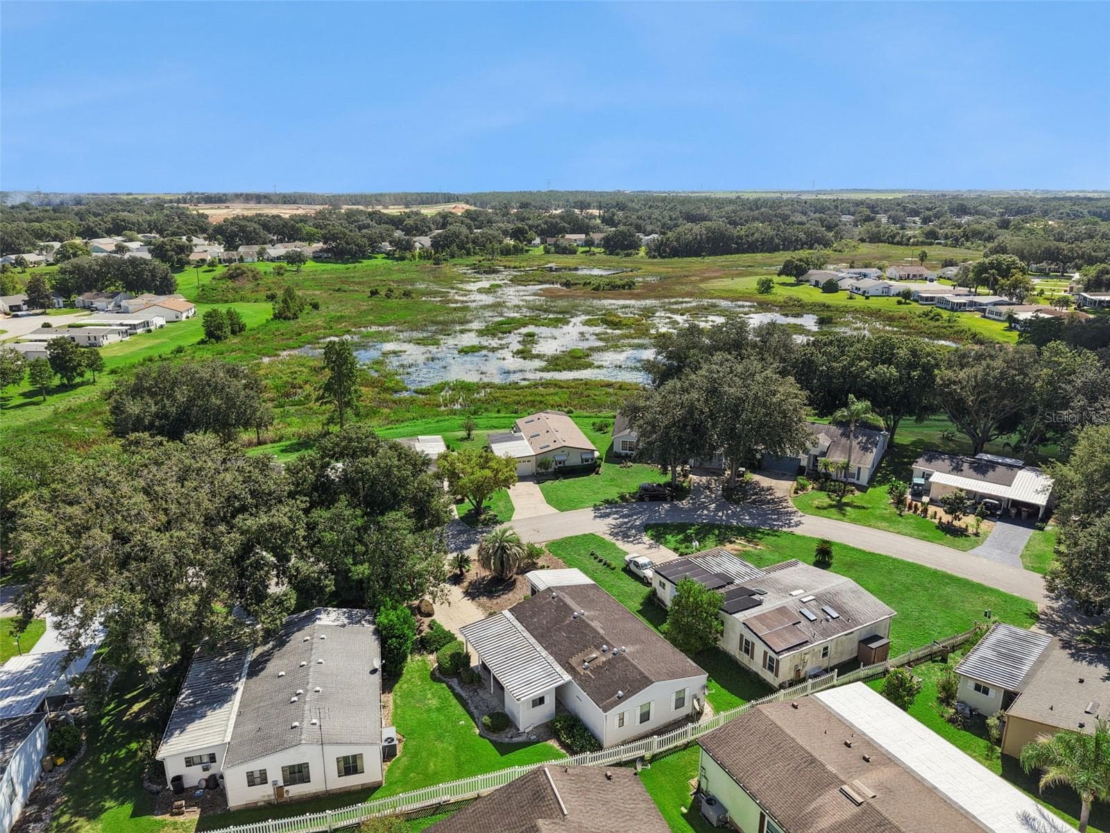 Aerial view across the neighborhood toward the marsh - 25038 CLIFFORD HL, LEESBURG