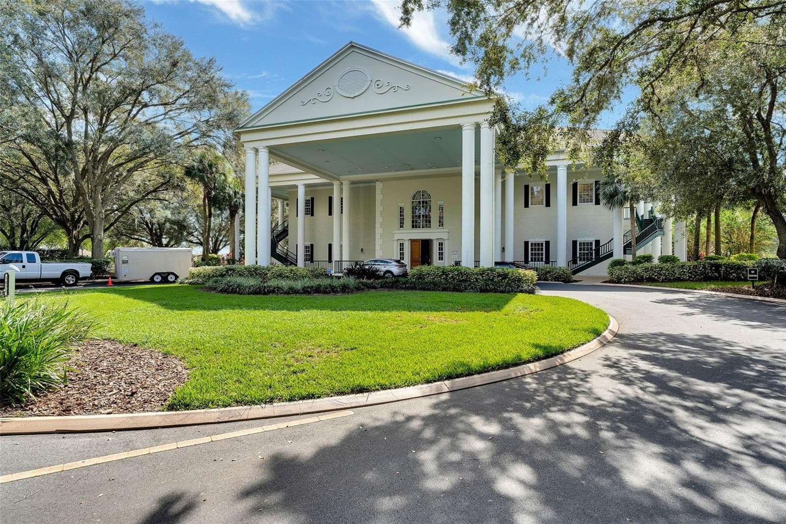 Community amenity: clubhouse exterior with a columned portico - 25038 CLIFFORD HL, LEESBURG