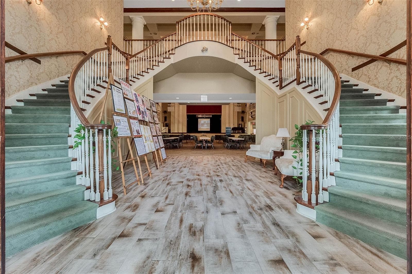 Community amenity: clubhouse foyer with double staircase leading to the main hall - 25038 CLIFFORD HL, LEESBURG
