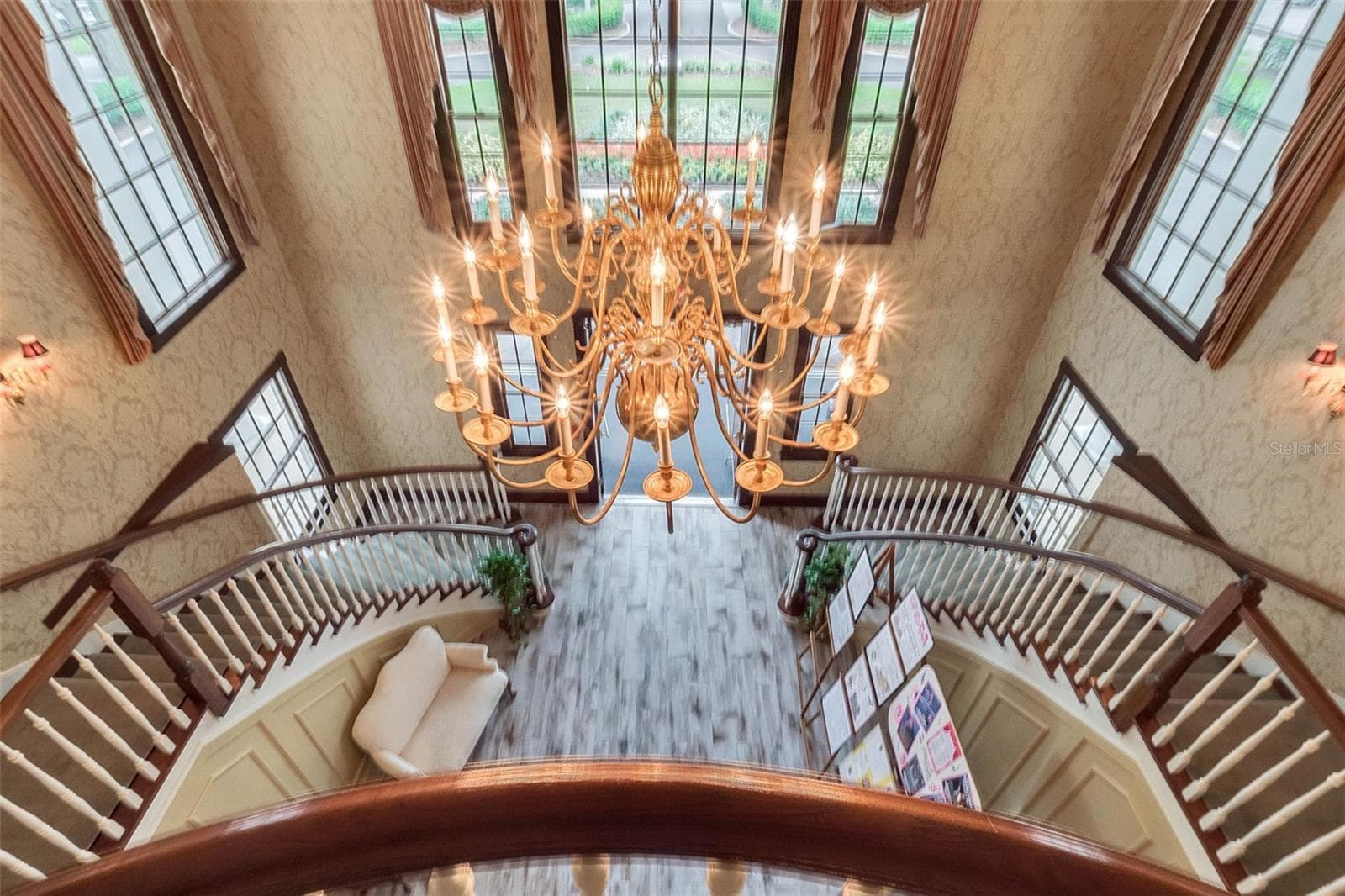 Community amenity: clubhouse foyer and chandelier seen from the upper landing - 25038 CLIFFORD HL, LEESBURG