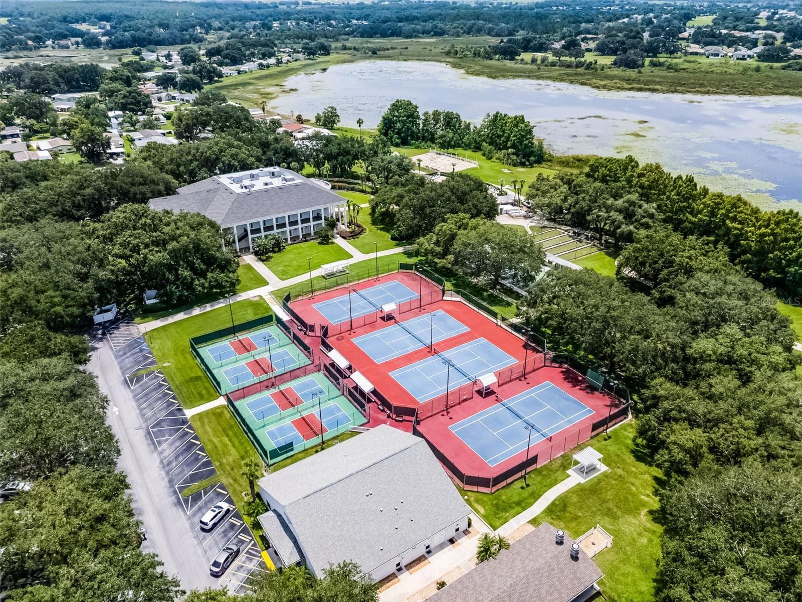 Community amenity: aerial view of the courts and clubhouse by the lake - 25038 CLIFFORD HL, LEESBURG