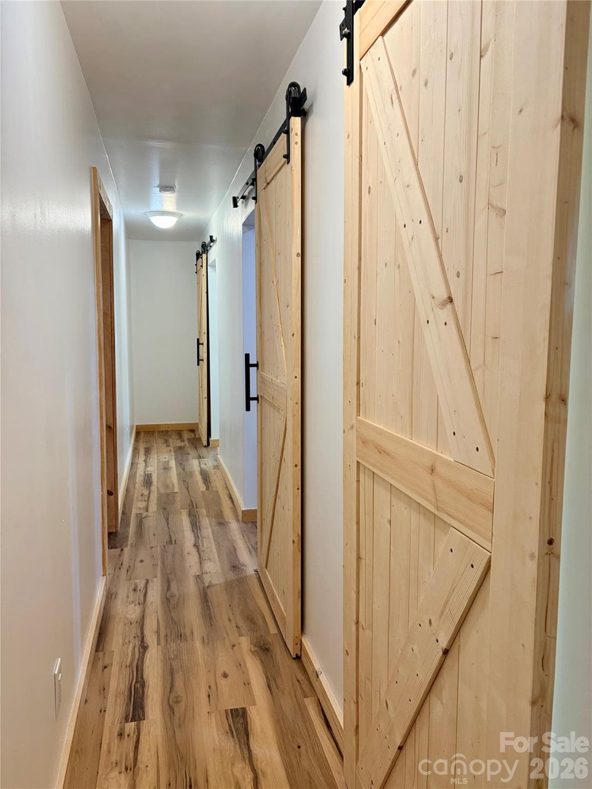 Hallway with sliding barn doors - 550 Dills Road, Rutherfordton