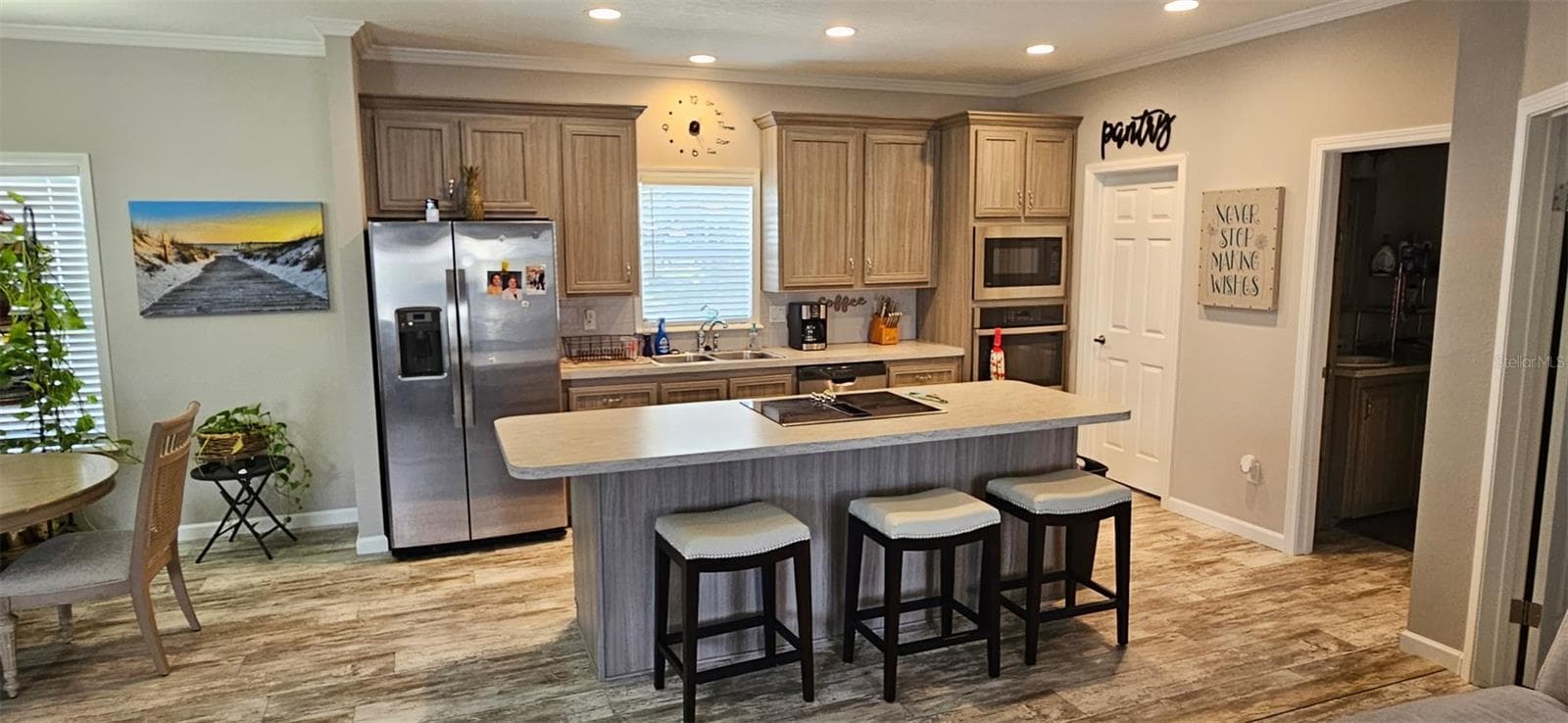 Kitchen showing cooktop and breakfast bar - 5652 HOLIDAY PARK BLVD, NORTH PORT