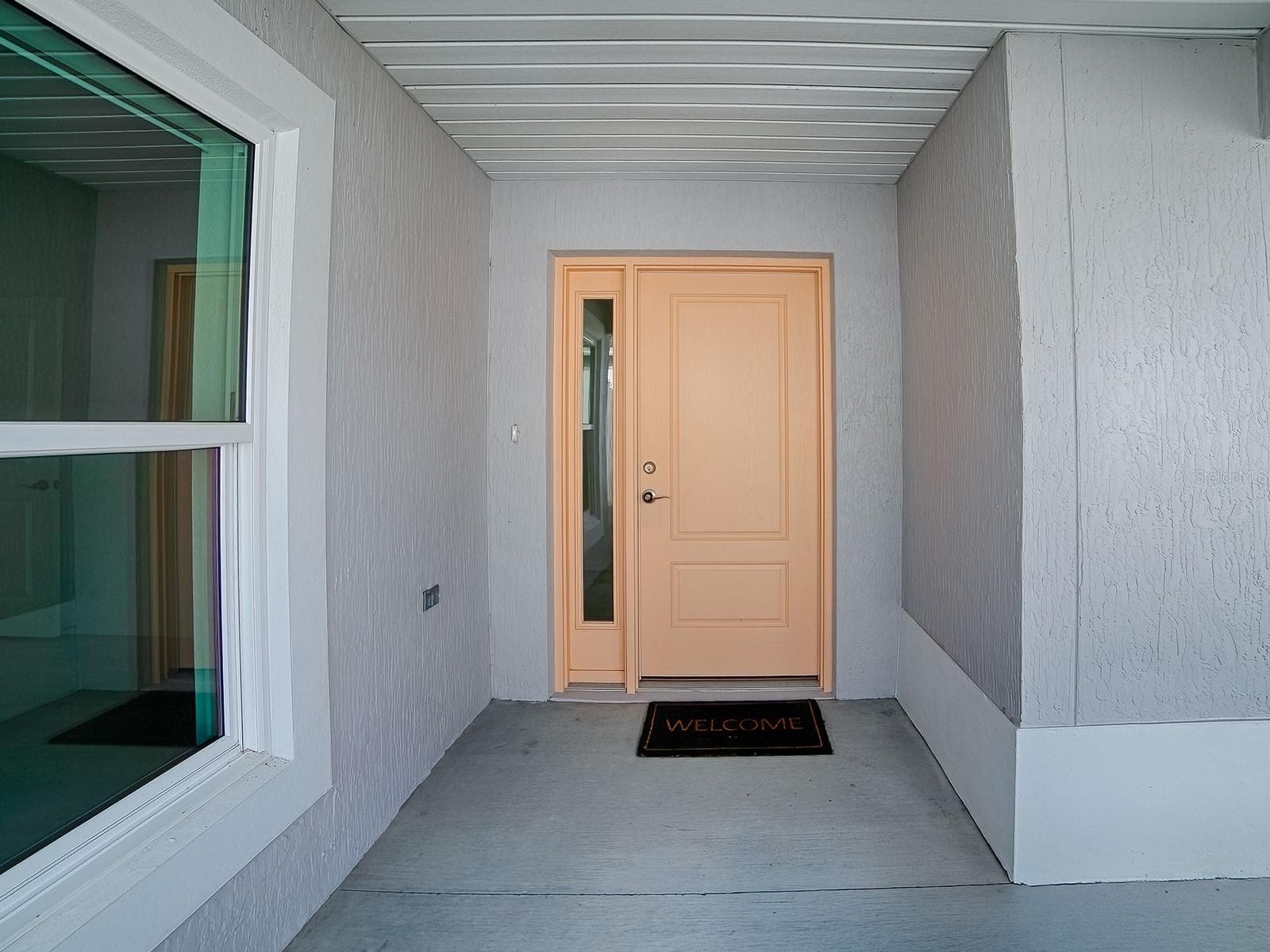 Front door from porch that comes on the left side of the home, ultras private - 1359 DARREN DR, THE VILLAGES