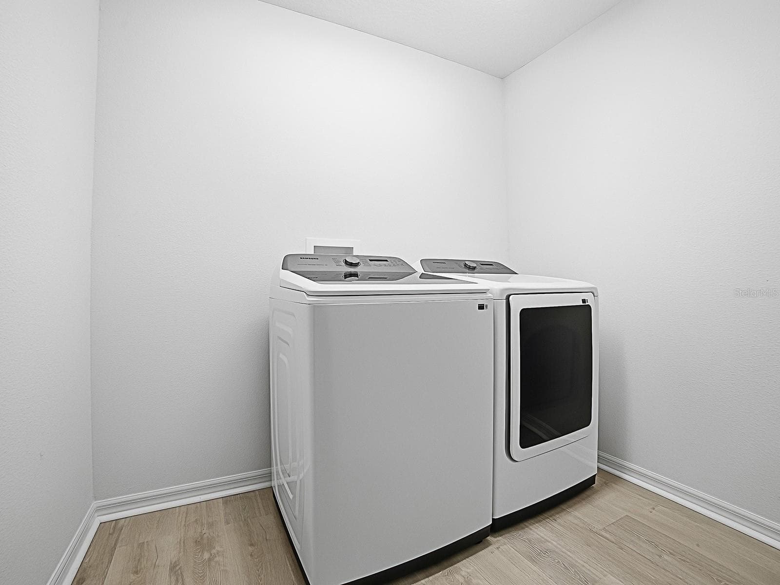 Washer dryer room, separate room in the hallway. Adding a set of cabinets above the washer dryer provides you with a lot of extra storage space - 1359 DARREN DR, THE VILLAGES