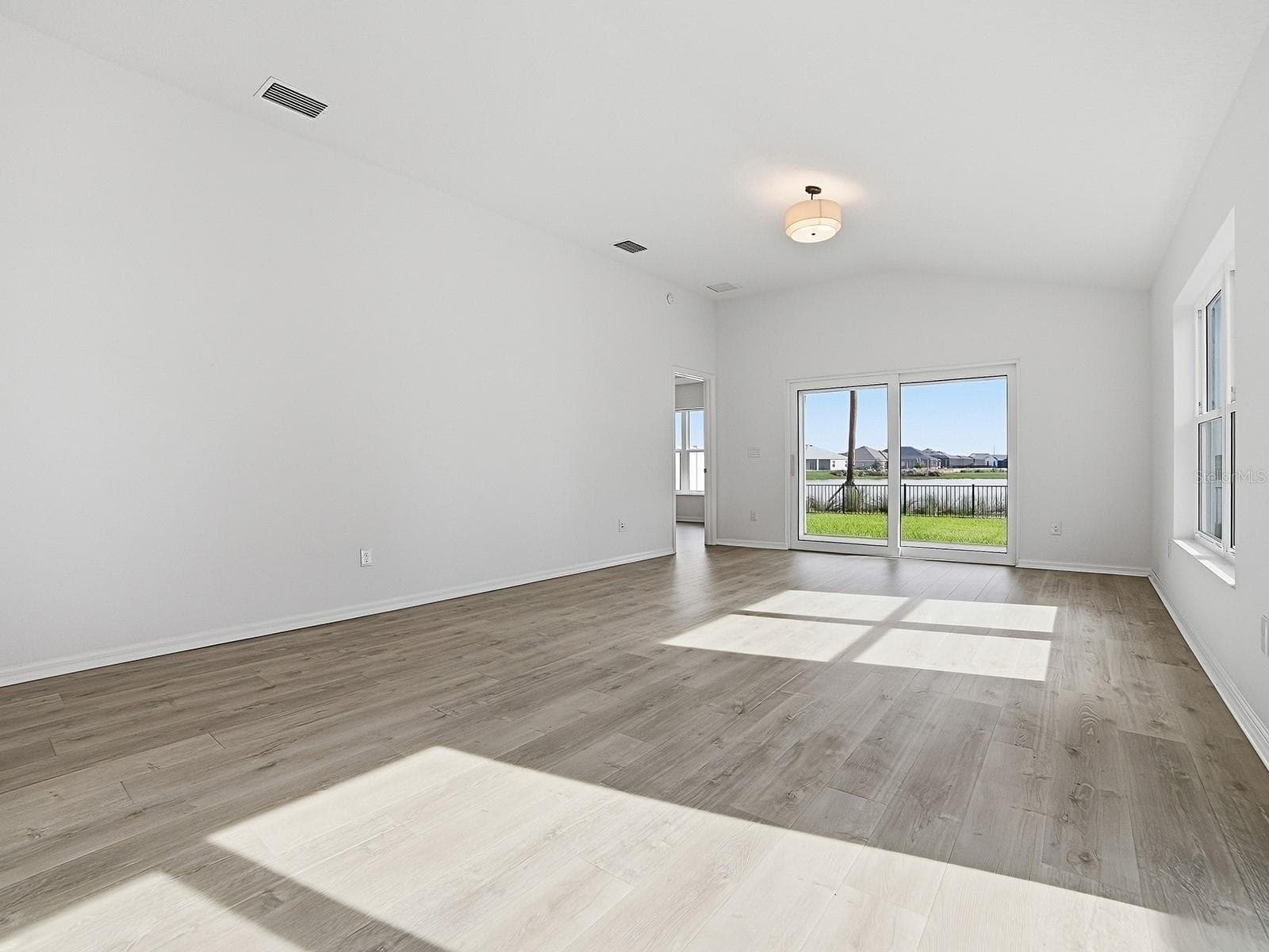 A view of the living room taken from the sliding door that give you access to a BIG grilling patio - 1359 DARREN DR, THE VILLAGES