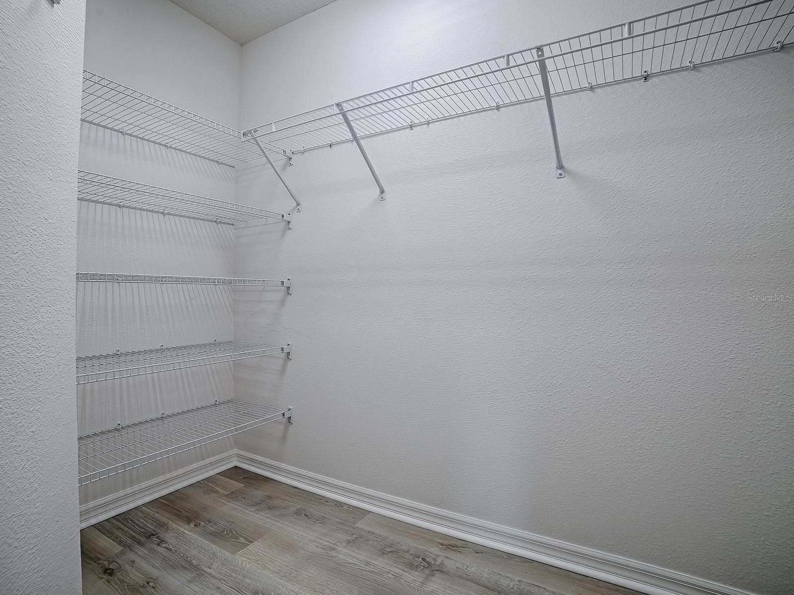 Primary bedroom closet, one of 2 leading to the bathroom - 1359 DARREN DR, THE VILLAGES