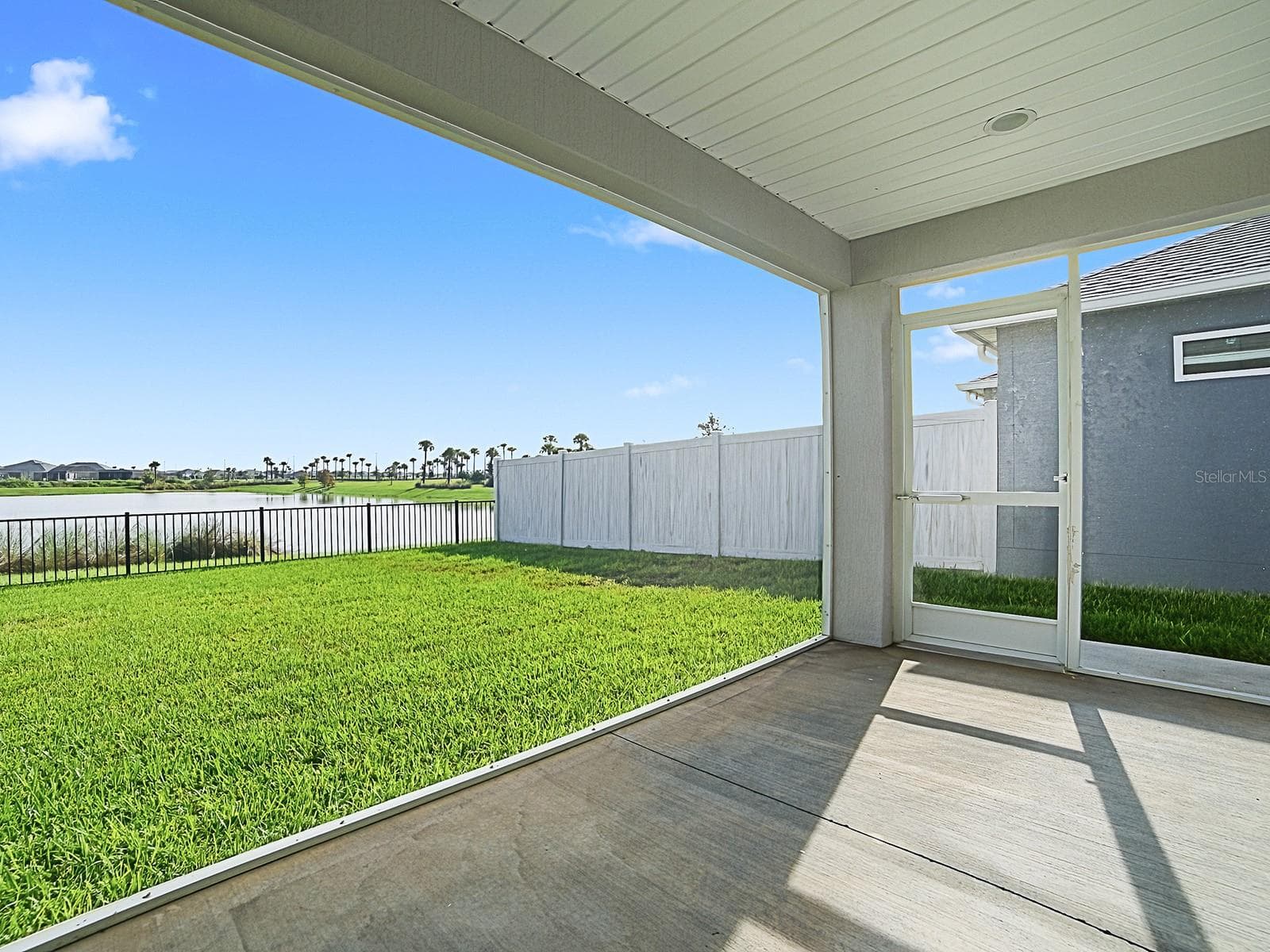 View of lanai and back yard from inside lanai - 1359 DARREN DR, THE VILLAGES