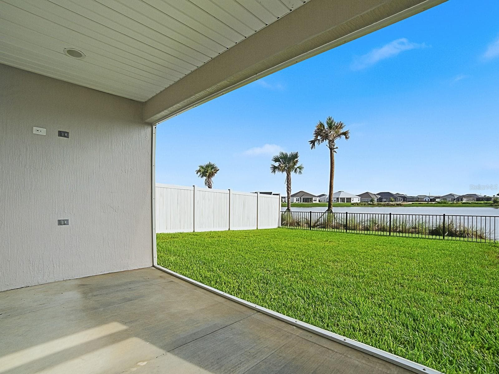 View of backyard and the pond from the lanai door - 1359 DARREN DR, THE VILLAGES