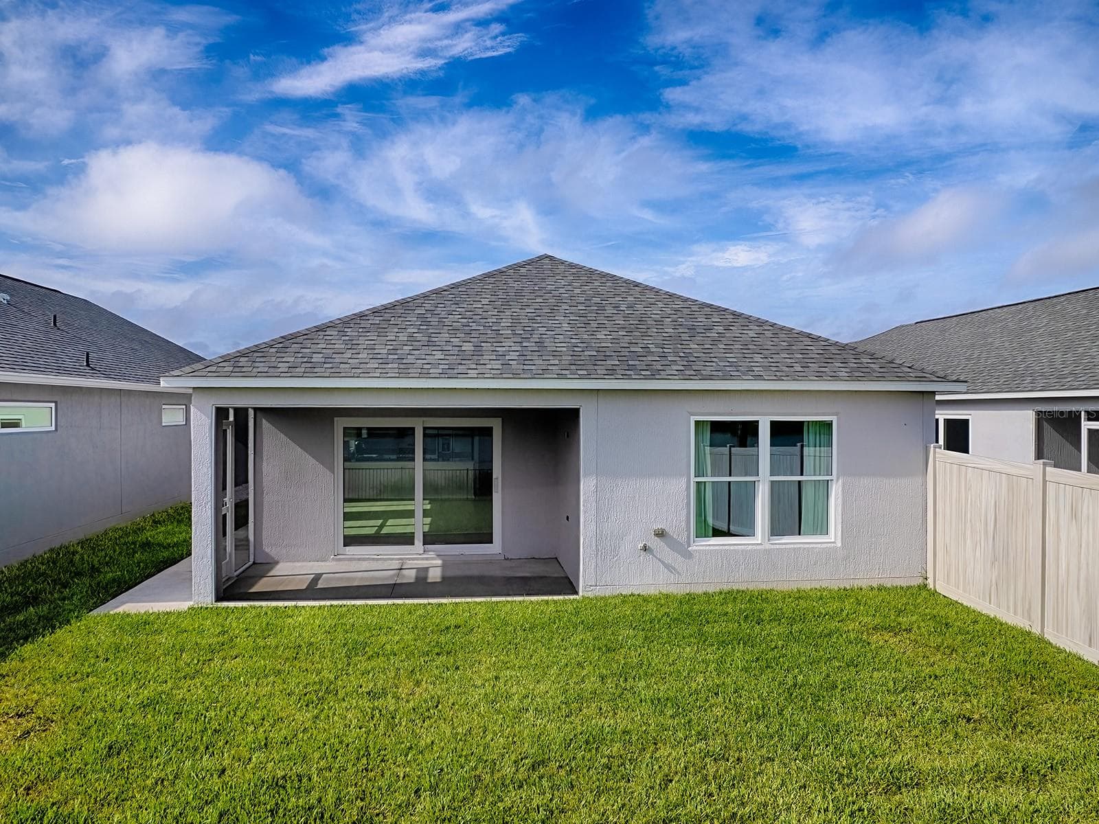 View of back of home view from a lowered drone - 1359 DARREN DR, THE VILLAGES