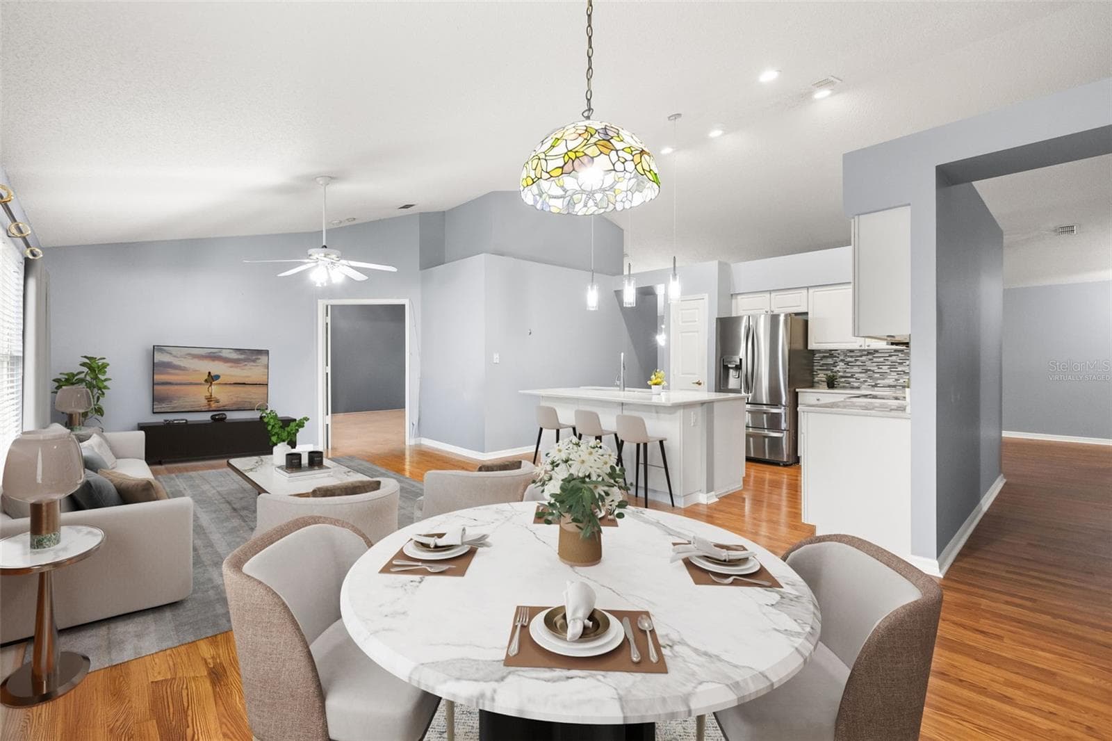 Virtually staged dinette and family room with views of recently updated kitchen and hallway to your secondary bedrooms and bath - 755 VIA MILANO, APOPKA