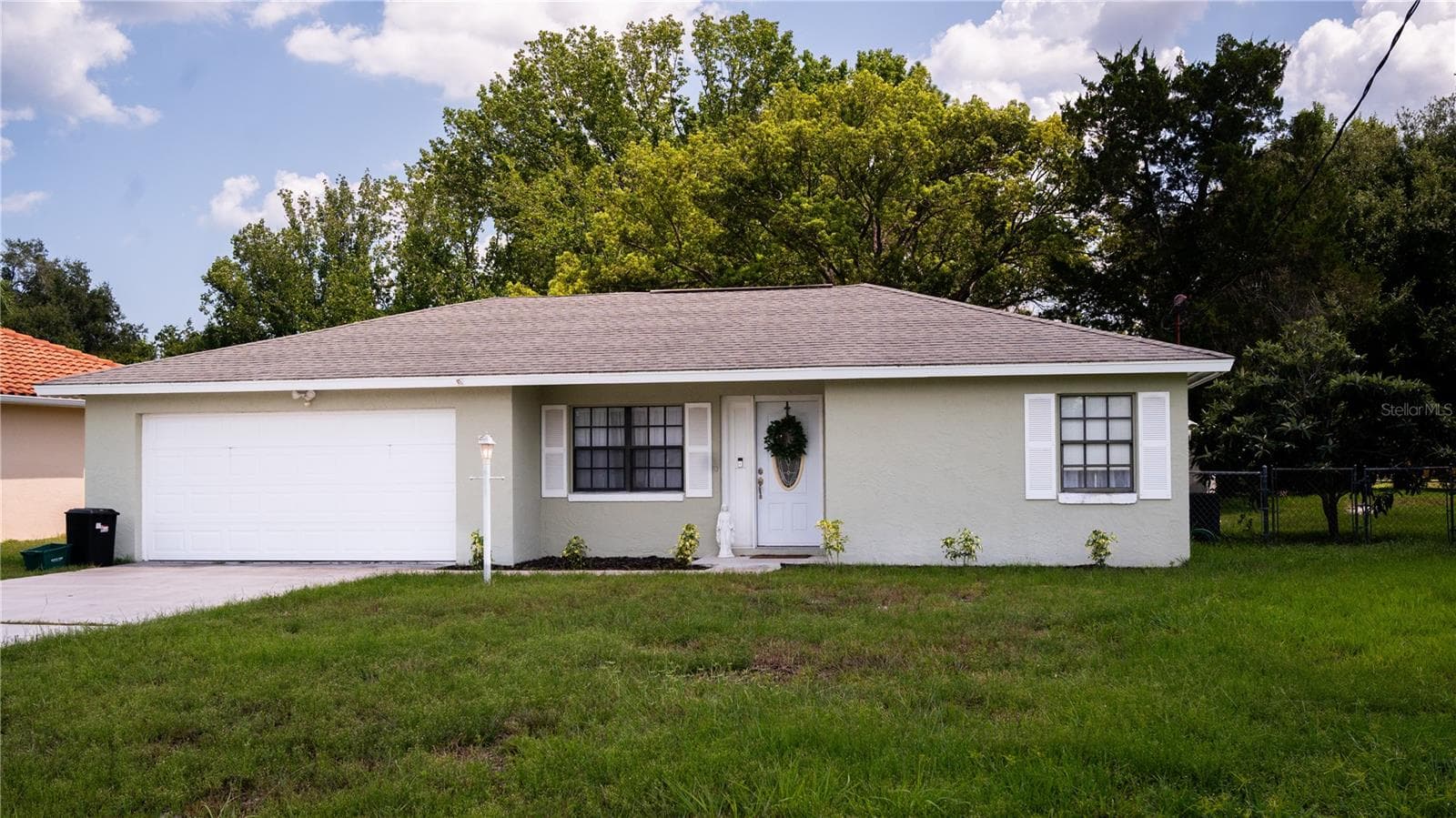 Front view of the house, showing off the exterior, yard, and driveway. - 57 FORRESTER PL, PALM COAST