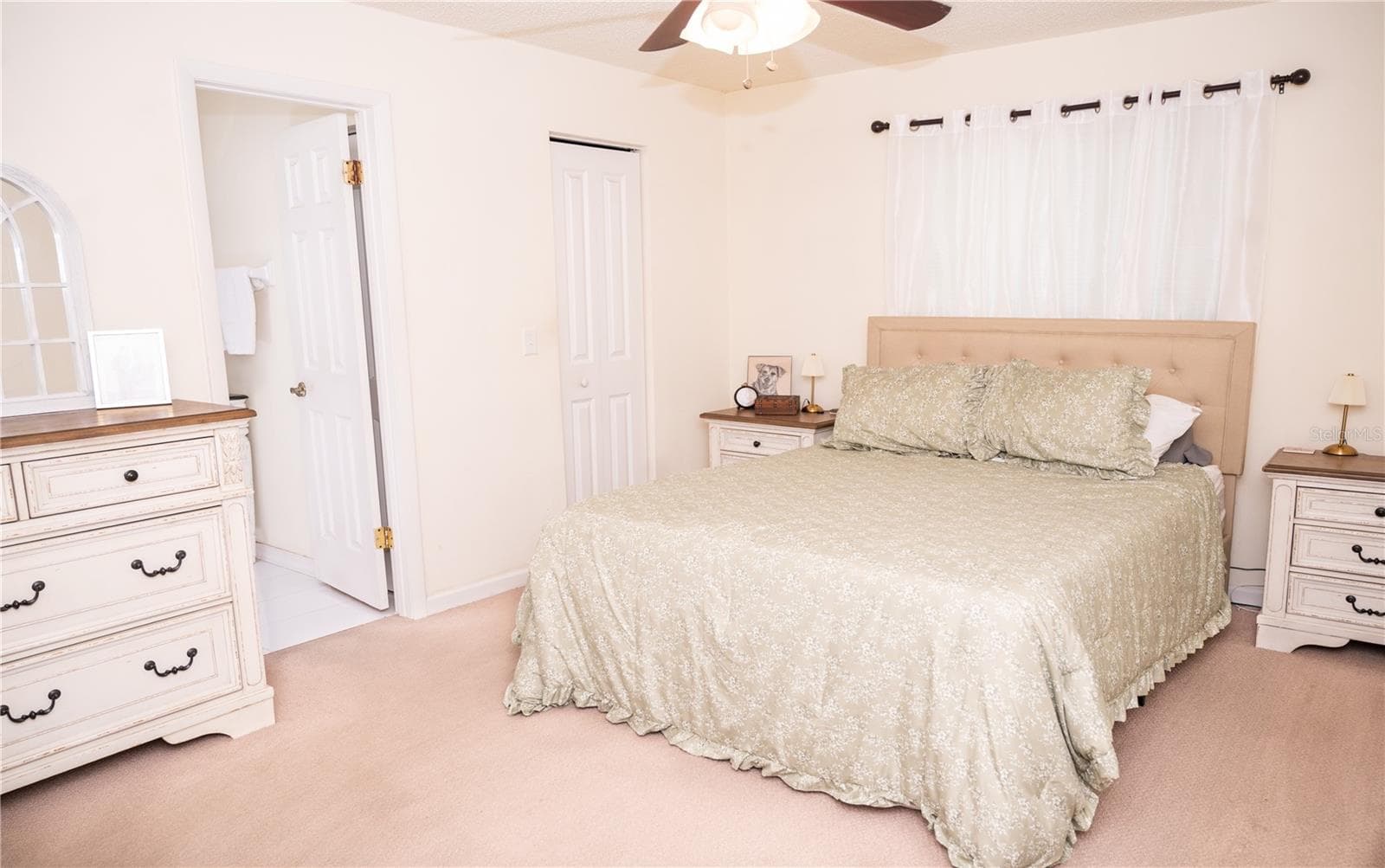 Primary bedroom view featuring the walk-in closet and primary ensuite bathroom. - 57 FORRESTER PL, PALM COAST