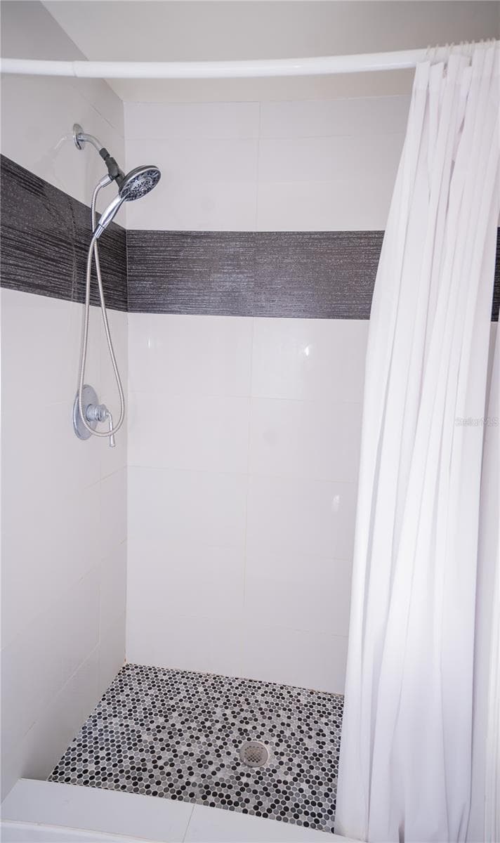 This custom shower features high-end designer tile work, premium fixtures, and luxury tile flooring. - 57 FORRESTER PL, PALM COAST