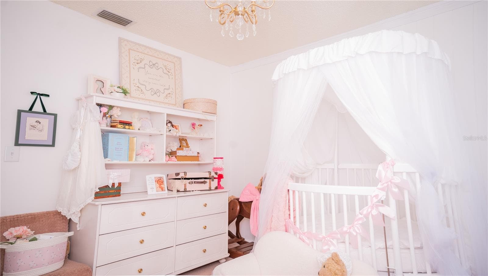 Another view of the nursery, complete with the chandelier ceiling fixture. - 57 FORRESTER PL, PALM COAST