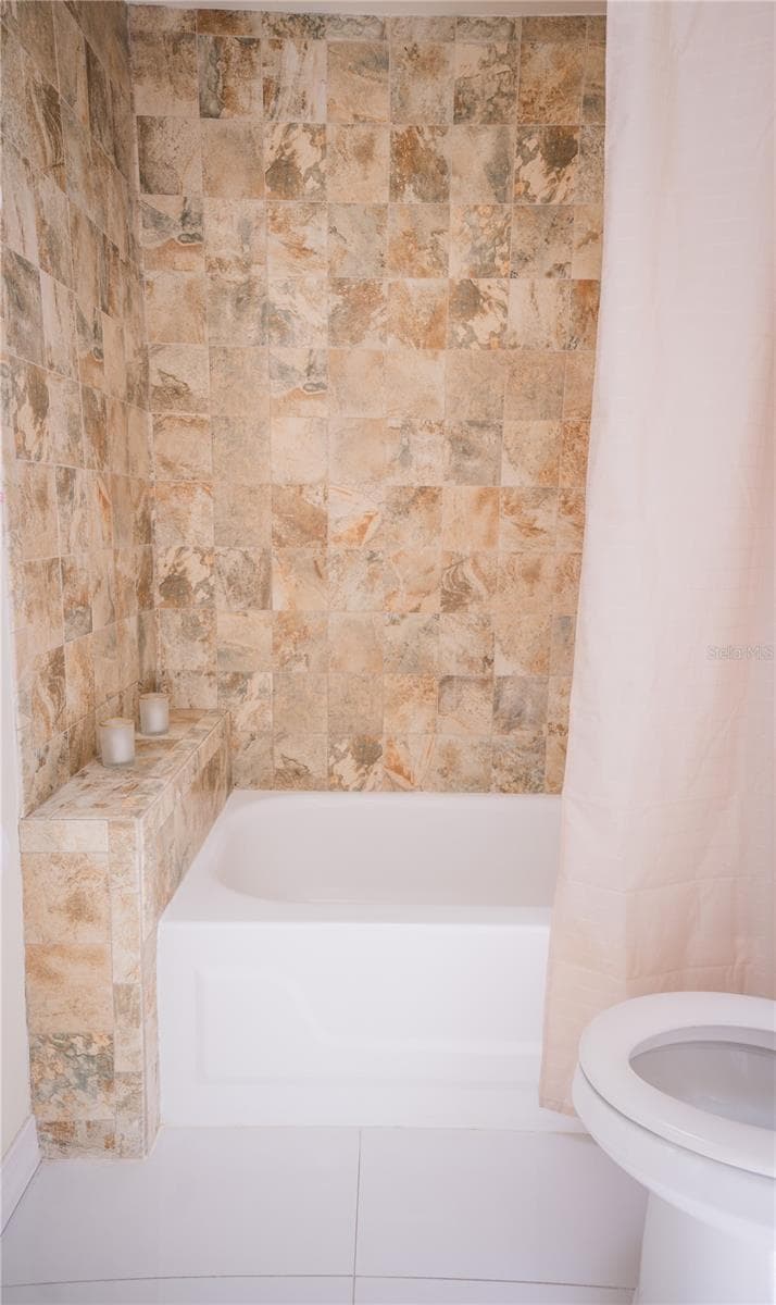 Beautifully tiled secondary bathroom featuring modern finishes and updated fixtures. - 57 FORRESTER PL, PALM COAST