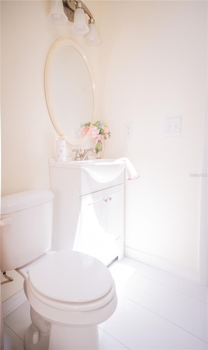 Modern vanity featuring sleek, elegant granite countertop with chrome hardware, and spacious cabinetry for optimal storage in the second bathroom. - 57 FORRESTER PL, PALM COAST