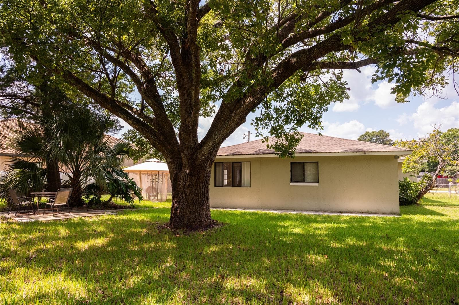 View from the back fence looking toward the rear of the house. - 57 FORRESTER PL, PALM COAST