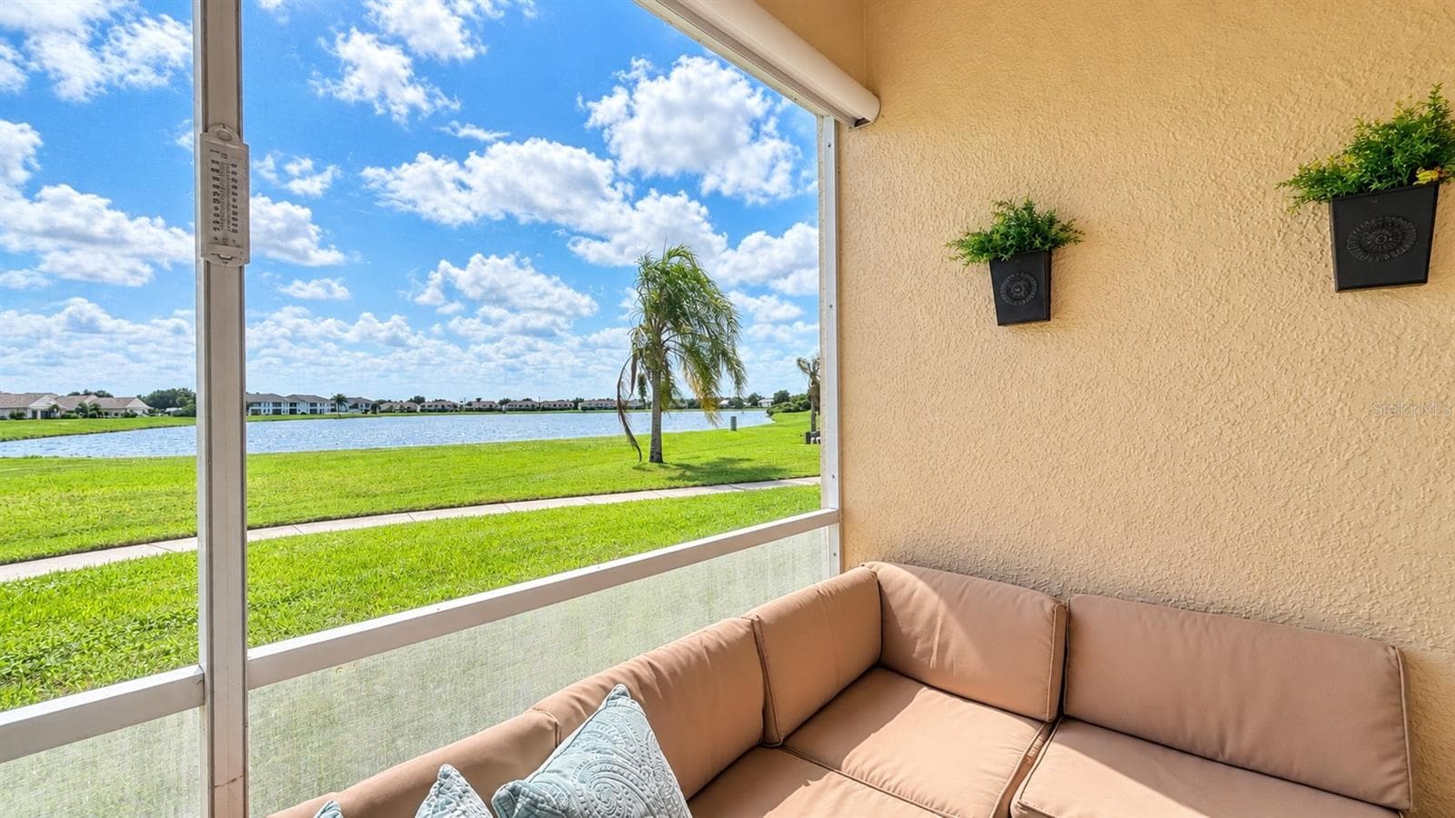 Front lake views from the enclosed screened lanai - 26397 NADIR RD #103, PUNTA GORDA