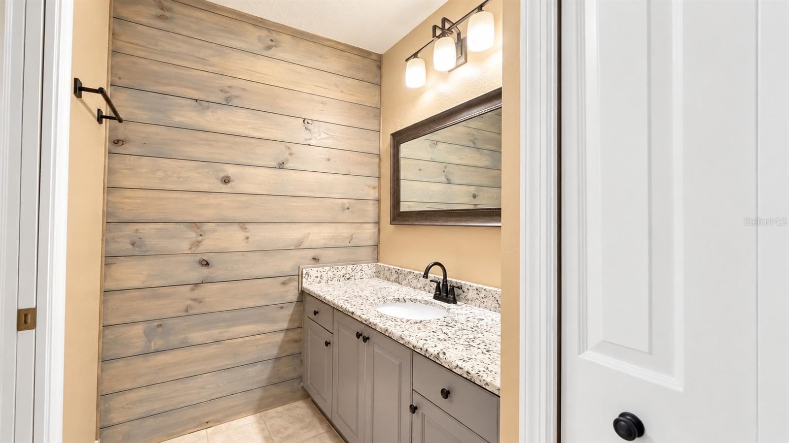 Coastal shiplap primary bathroom - 26397 NADIR RD #103, PUNTA GORDA
