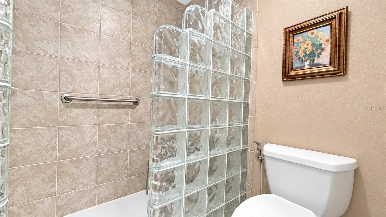 Primary bathroom with modern look of glass blocks - 26397 NADIR RD #103, PUNTA GORDA