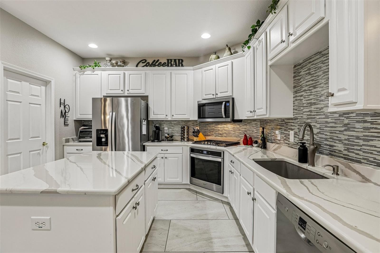Kitchen with marble counters - 27443 MISTFLOWER DR, WESLEY CHAPEL