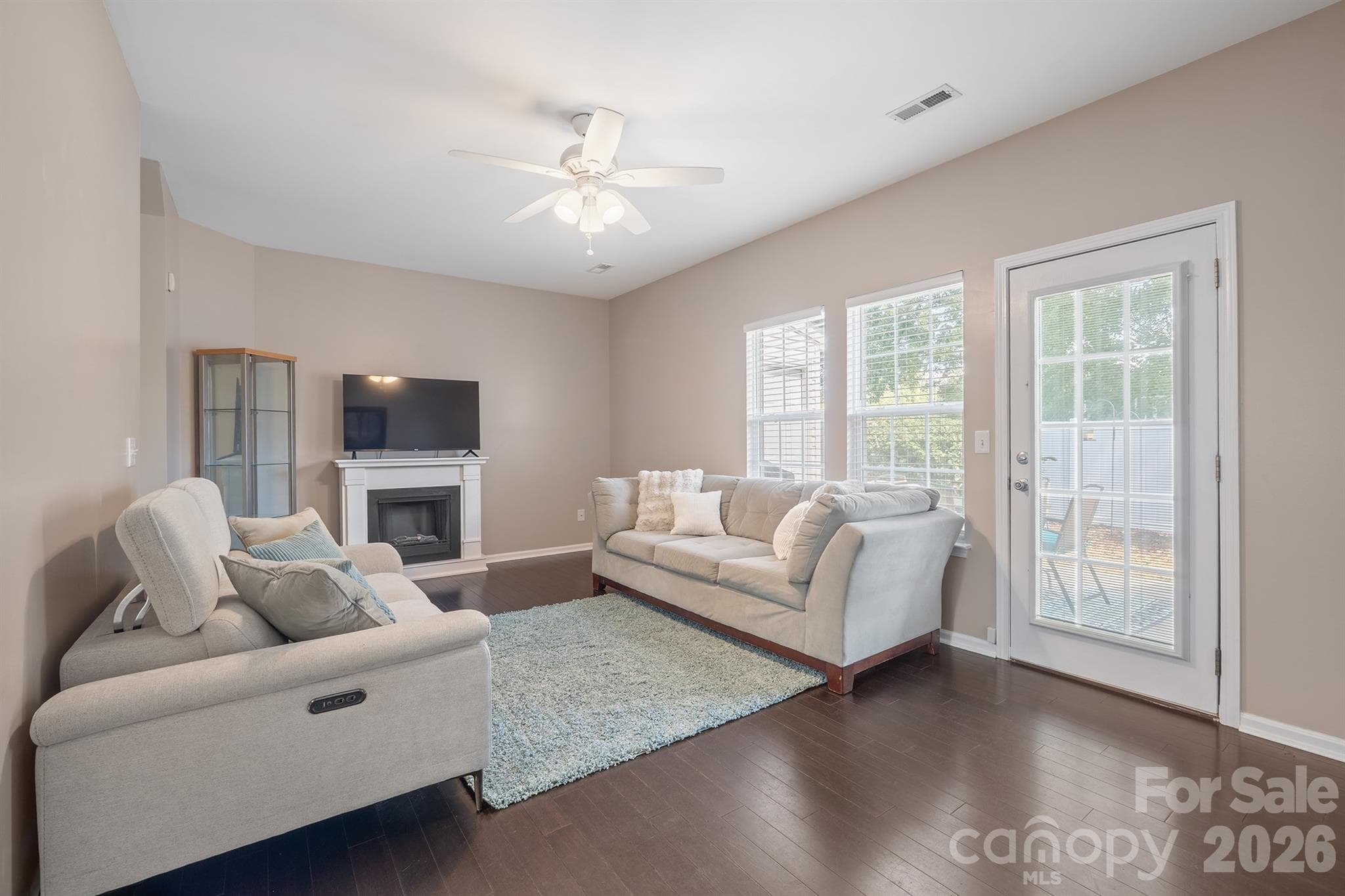 Living room with bamboo flooring and a door leading to the private back patio. - 4144 Kenton Glenn Court NW, Concord